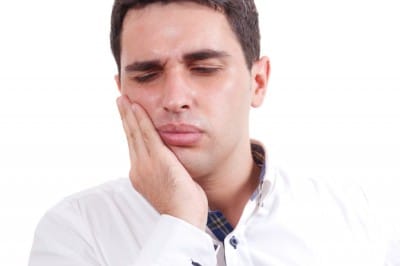 A man suffereing from Jaw Pain