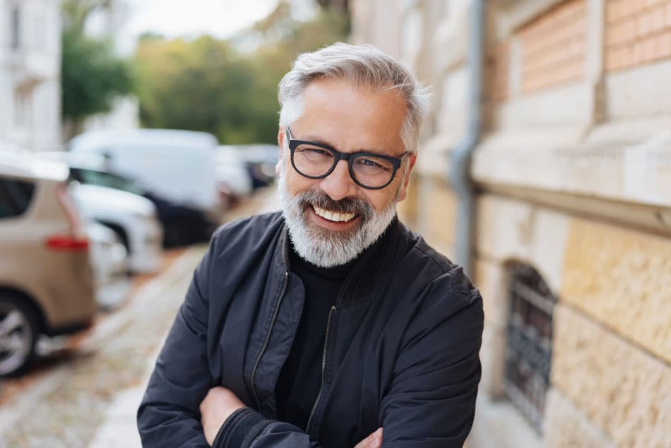 handsome man, smiling and folding his arms