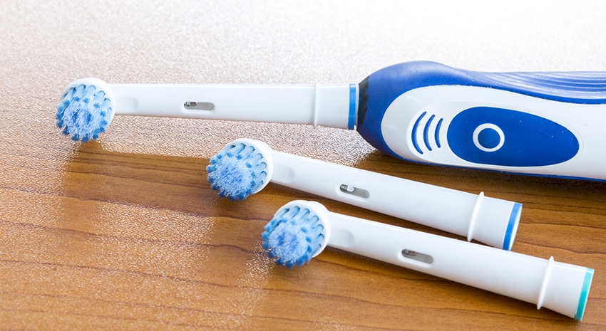 Electronic toothbrush with toothbrush heads on white