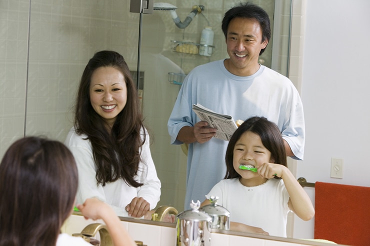 A family brushing their teeth together
