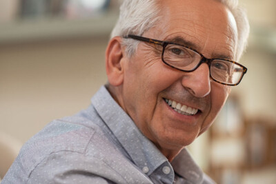 senior man showing off his confident smile with dentures