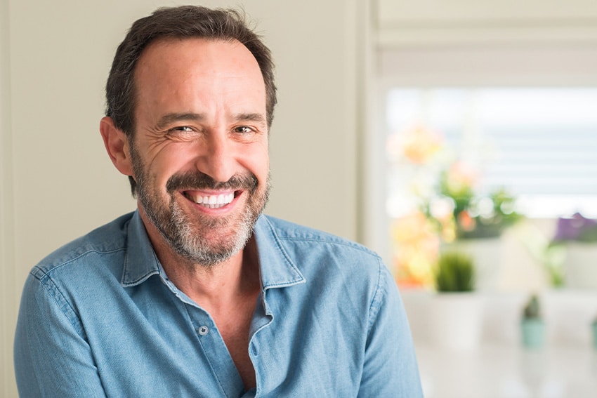 mature man relaxing in his kitchen