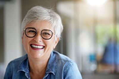 mature adult woman smiling with teeth