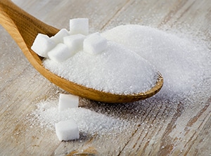 Sugar on a wooden spoon