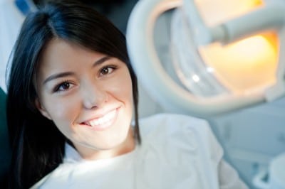 A happy young lady getting a dental exam